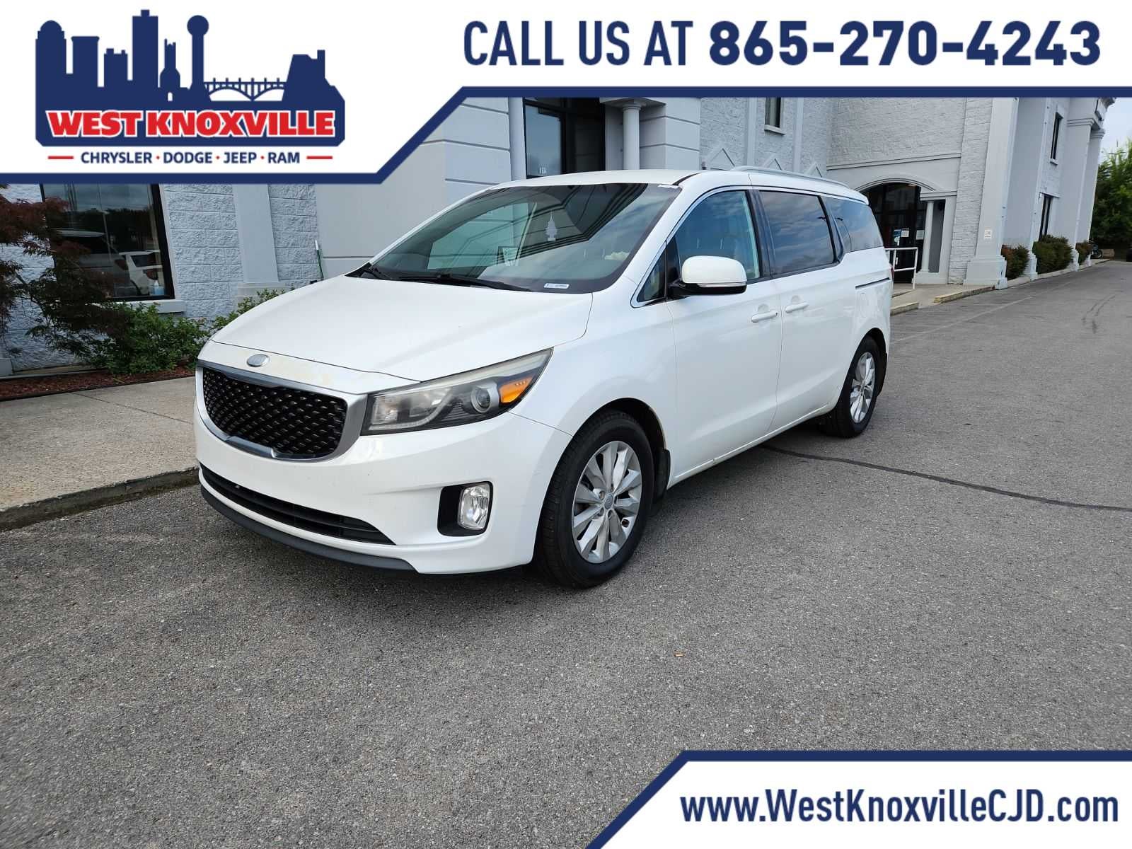 2015 Kia Sedona EX in Snow White Pearl — front three-quarter view